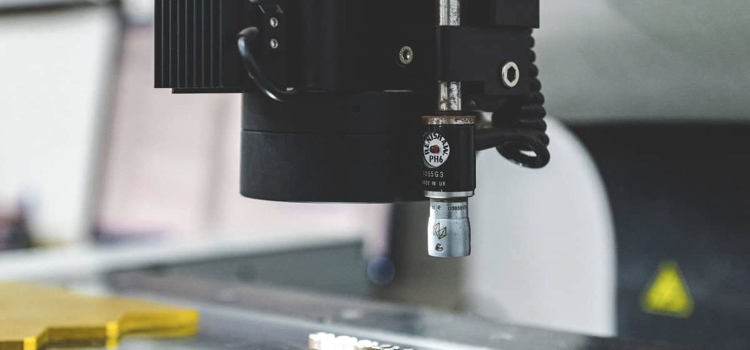 Coordinate measuring machine inspecting a component